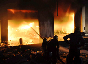 Firemen extinguish flames that engulfed a confectionery company on NH-8, near Manesar, in Gurgaon on Friday.