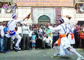 Sikh men play 'Gatka' during a religious procession at the Sis Gunj Gurdwara in New Delhi on Saturday.