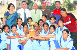 The SGRR School Race Course volleyball team pose with the Inter-School Volleyball Tournament trophy in Dehradun on Saturday