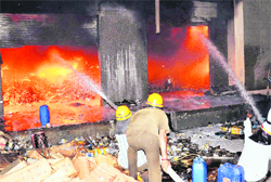Firemen douse the flames at the factory near Manesar on Friday