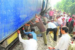 Railway mechanics inspect the site of the train derailment in Ludhiana
