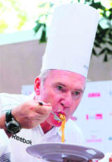 Delhi Marathon 2009 ambassador Allan Border enjoys pasta at the Pasta Ceremony during the event in New Delhi on Saturday.