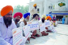 Family members of 1984 riots victims protest under the banner of the All-India Sikh Students Federation at Bangla Sahib Gurudwara in New Delhi
