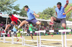 Participants in a hurdle race at the annual sports day of Scholars' Home School in Dehradun on Sunday. 