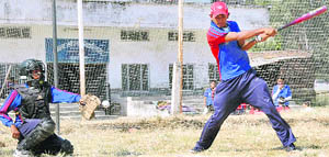   A player in action at Baseball Inter-School Tournament in Dehradun on Sunday. 