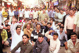 Members of the Raghunath Bazaar Shopkeepers Association stage a protest in Jammu on Sunday. 