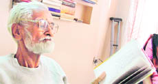 Muhay reading one of his books at home afte receiving the degree.