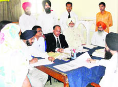 Hearing of cases in progress during a Lok Adalat organised in Jagraon courts.