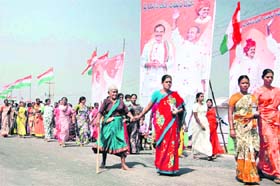 Tribal women from Andhra Pradesh arrive to take part in the first public meeting of CM Rosaiah in Chevella village