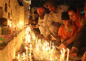 Devotees lighting up candles in the evening