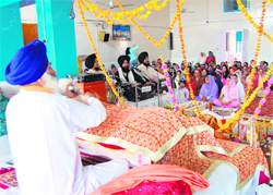 Ragis singing a shabad with the sangat sitting in front, listening to the Gurbani with religious zeal and reverence, at a well-decorated gurdwara on the occasion of Guru Nanak Devs birth anniversary celebrations in Dharamsala