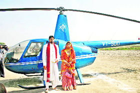 Deepak Rao and his wife, Sonal, pose with the helicopter which brought them to the bridegrooms Balambh village (Rohtak) after their marriage on Friday.