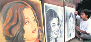 Shanty-dweller and self-taught artist Ramzan Hussain gives the final touches on the portrait of Bollywood actror Aishwarya Rai Bachchan her birthday in Kolkata on Sunday.