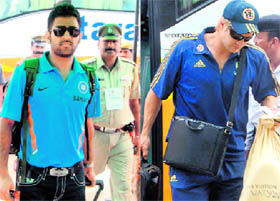 Mahendra Singh Dhoni and Shane Watson carry their luggage before leaving Chandigarh on Tuesday.