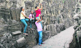 Girls take photographs at the Rock Garden in Chandigarh on Tuesday.