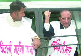 BJP leader V.K. Malhotra and other party workers demonstrate against the hike in fares of DTC buses in New Delhi