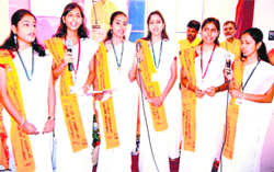 Students sing hymns before the start of a yoga seminar in Haridwar