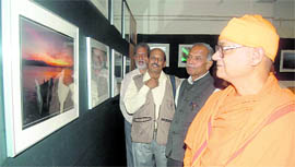 Swami Nirvikalpanand at a photo exhibition of Debatosh Sengupta at the UGB art gallery in Dehradun on Tuesday.