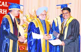 Prime Minister Dr Manmohan Singh hands over a degree to a doctor at the annual convocation of PGIMER in Chandigarh