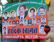 A policeman looks at a hoarding outside MC office in Jalandhar on Tuesday.