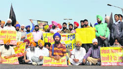 Activists of Sikh organisations stage a dharna on Jagraon bridge, disrupting traffic in the city on Tuesday.