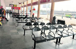A few passengers at the almost empty interstate bus terminal
