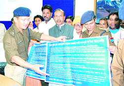 Haridwar SSP Sanjay Gunjiyal with ASP Arun Mohan Joshi dsplay a directions list for Maha Kumbh