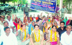 Ward members of the Haridwar Municipal Committee protest in front of the Kumbh Mela office in Haridwar