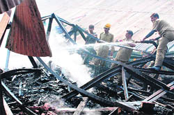 Fire-fighters control the blaze in a saw mill in the Palora area of Jammu on Wednesday.