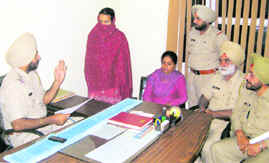 The woman accused of killing her seven-year-old stepson, in police custody at Mandi Ahmedgarh. 