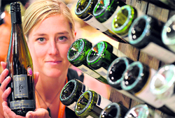 Winemaker Lisa Coney holds a bottle of Riesling produced by her family in New Zealand at the International Wine and Spirits Fair in Hong Kong on Thursday. Over 520 exhibitors from 34 countries are taking part in the three-day exhibition.