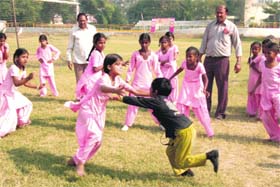 Girls play kabaddi during the two-day Block Level Primary School Tournament at the Memorial Stadium, Ambala Cantt.