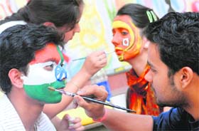 Students take part in a face painting competition at Panjab University in Chandigarh