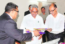 Uttarakhand Tourism Secretary Utpal Kumar Singh (extreme right) exchanges papers with Ramesh Ramanathan, MD, Mahindra Holidays, after signing an MoU as state Tourism Minister Madan Kaushik (centre) looks on in Dehradun on Thursday. 