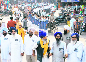 Residents of Karnal donning black badges form a chain to press for a medical college in the city named after Kalpana Chawla.