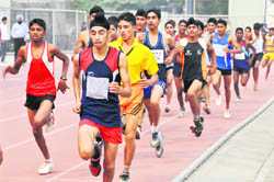 Boys (under 17) take part in the final of the 1500m race on the opening day of the 56th Punjab School Games being held at Guru Nanak Stadium in Ludhiana on Thursday.