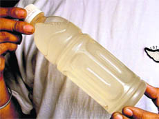 A man shows dirty water being supplied in Fatehgarh Mohalla, Ludhiana, on Thursday.
