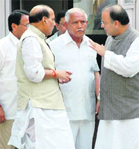 BJP chief Rajnath Singh and party senior leader Arun Jaitley have a word with Karnataka Chief Minister BS Yeddyurappa in New Delhi on Thursday.
