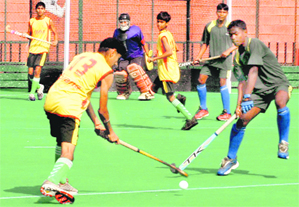 Players vie for the ball during a match at the Sector 42 Hockey Stadium, Chandigarh.