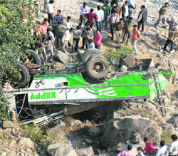 The mangled remains of the private bus which fell into a gorge at Haripur Guler village, 45 km from Dharamsala, on Friday.