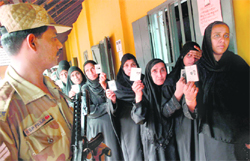 Muslim women, queued up to caste their votes at the Assembly bypoll, show their ID cards in Kannur