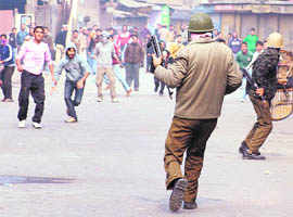 Protesters hurl stones at policemen during a protest after the body of a Saraie Balla resident was found, in Srinagar on Saturday.