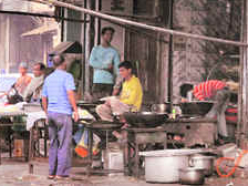 Workers at a dhaba prepare food in unhygienic conditions.