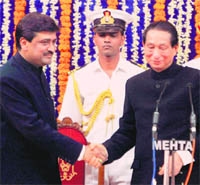 Maharashtra CM Ashok Chavan being greeted by Governor SC Jamir after the oath-taking ceremony in Mumbai on Saturday.