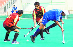 A hockey match in progress at the Hockey Stadium, Chandigarh, on Sunday. 