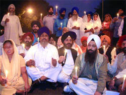 Kin of 84 riots victims with SAD workers take out a candlelight procession in New Delhi on Sunday.