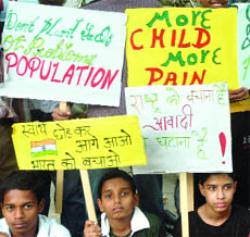 Children take part in a protest against increasing population at Jantar Mantar in New Delhi on Sunday.