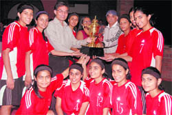 The Welham Girls School Basketball team receives the Council School Basketball Tournament for Girls trophy in Dehradun on Sunday. 
