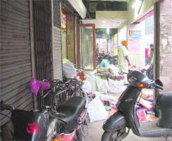 A corridor being used as a parking lot and a store in Ludhiana.
