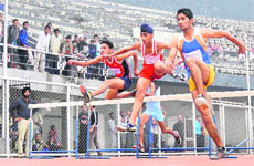 Athletes take part in the 100m dash on the penultimate day of the 56th Punjab School Games in Ludhiana on Sunday.